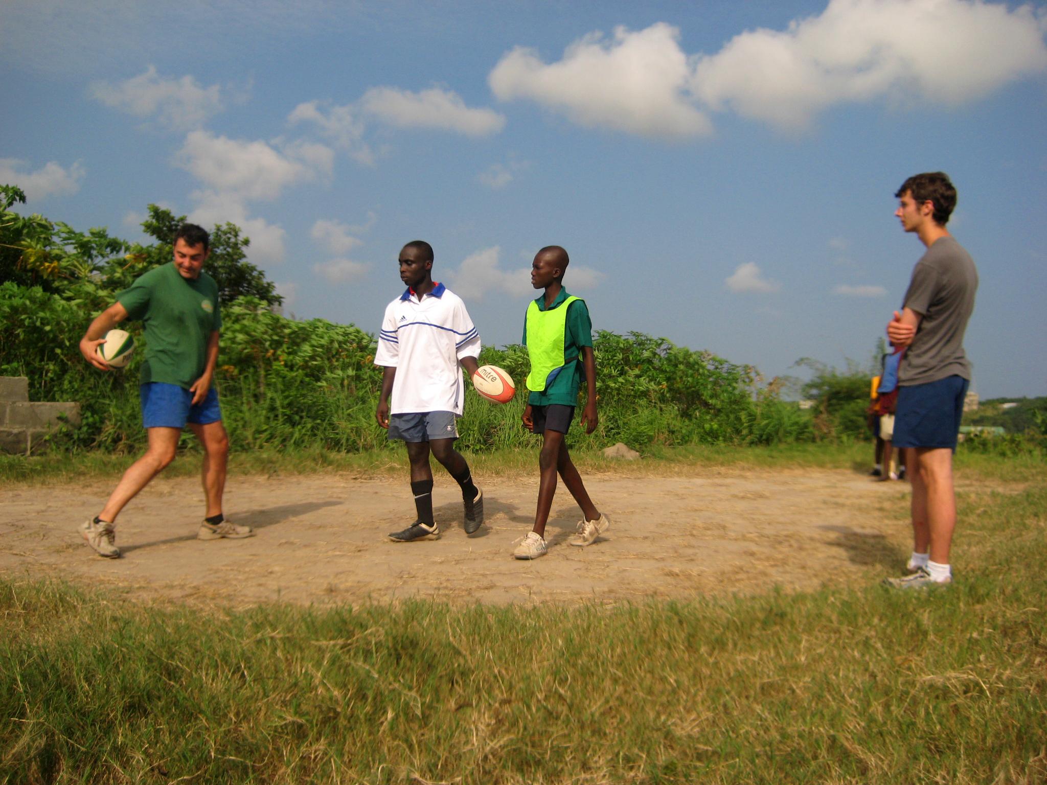 A Projects Abroad volunteer coaching rugby in Ghana holds a team practice A volunteer teaching rugby in Ghana demonstrates passing techniques to local players